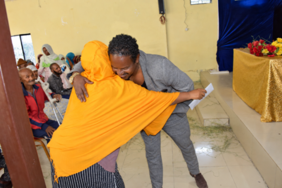 Sheme greeting one of the community members